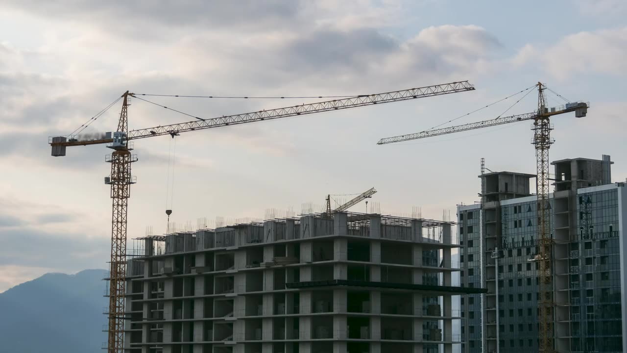 Tower cranes over a building under construction