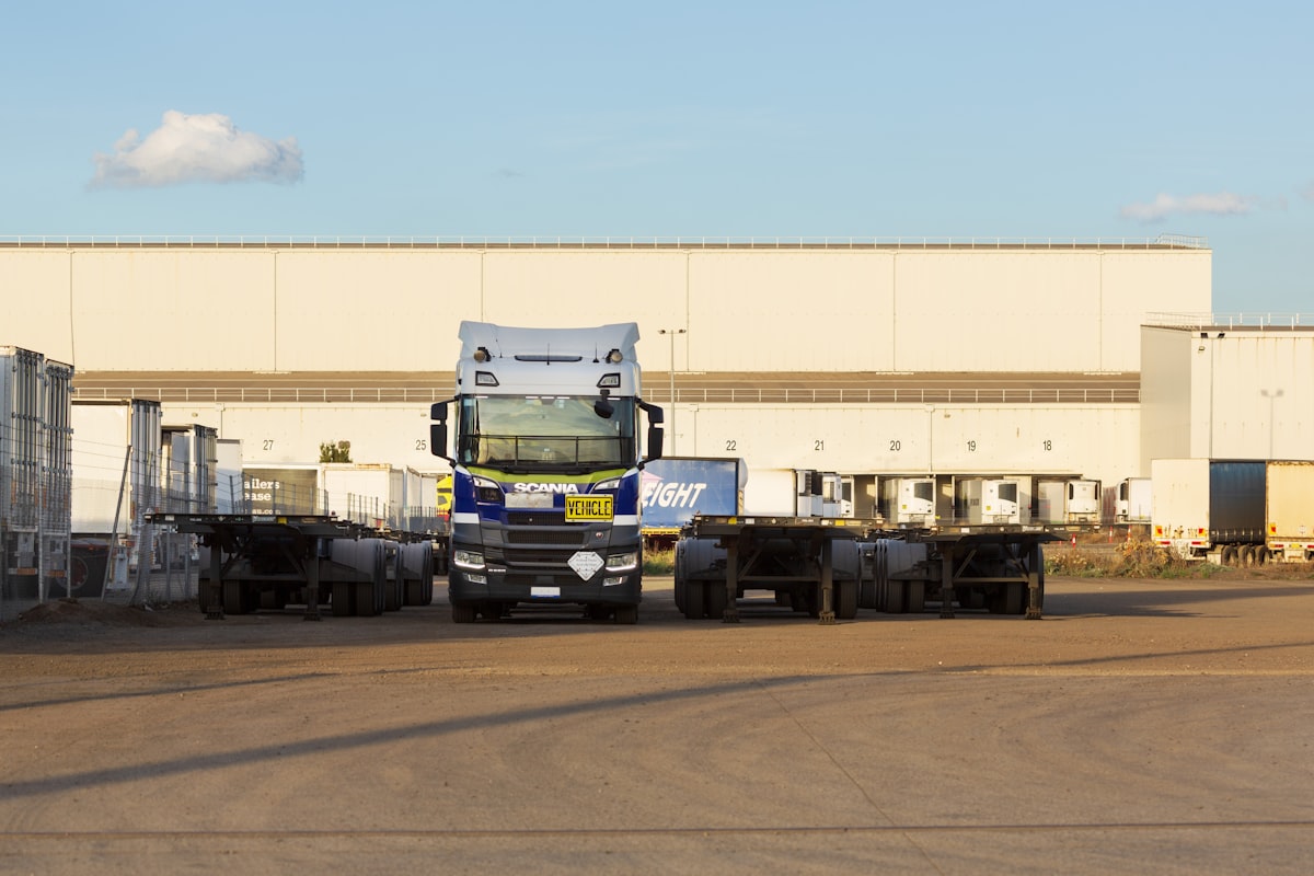 Tractor unit backed up to a numbered dock door at a distribution warehouse